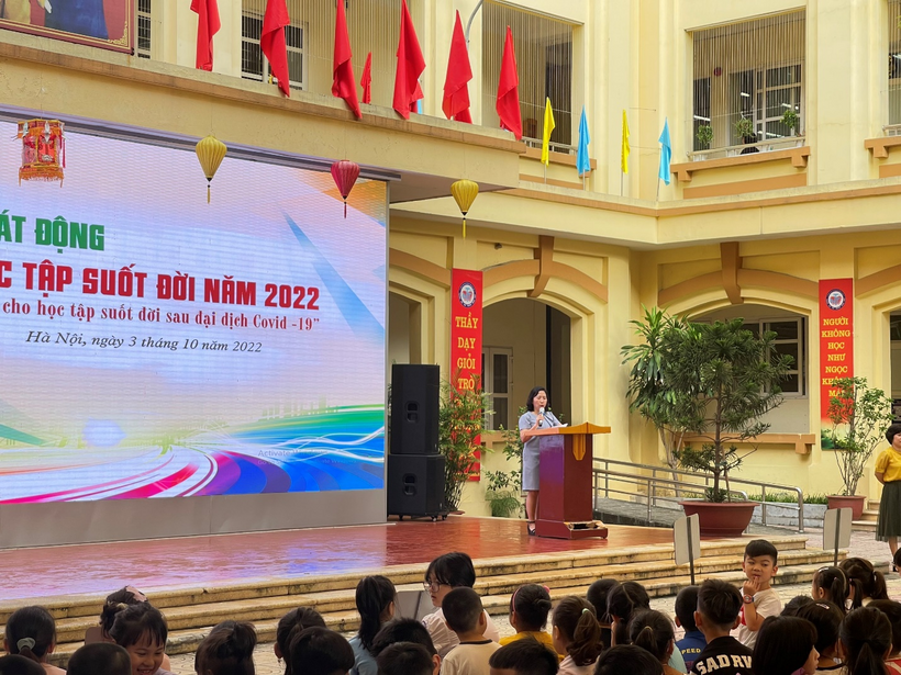 A picture containing text, person, people, building

Description automatically generated