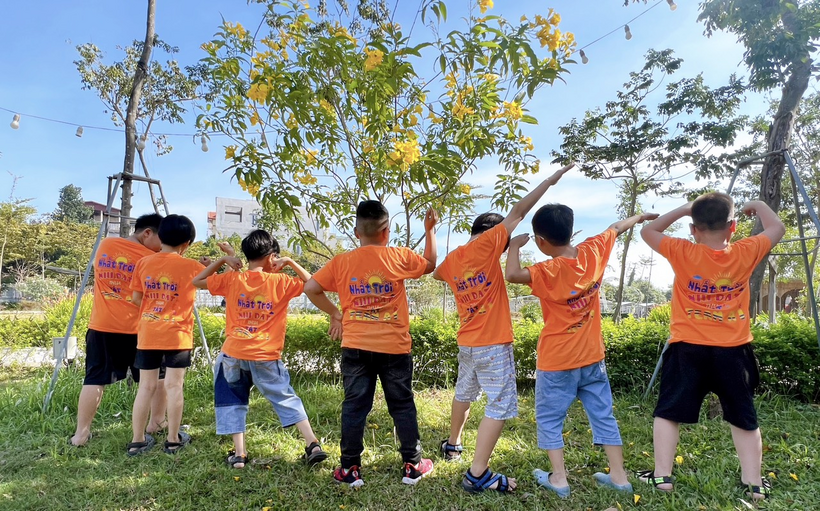A group of people wearing orange shirts

Description automatically generated with low confidence