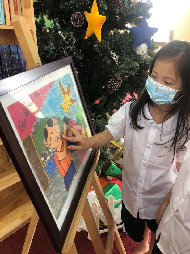 A child painting a picture
Description automatically generated with low confidence