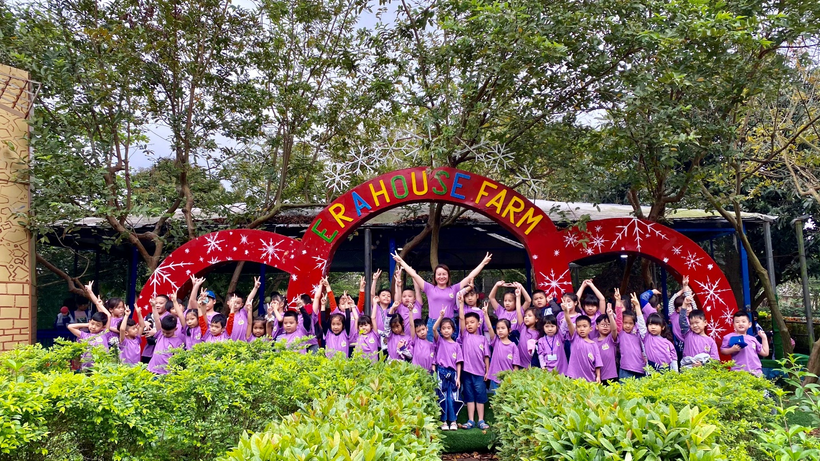 A group of people posing for a photo in front of a sign

Description automatically generated with medium confidence