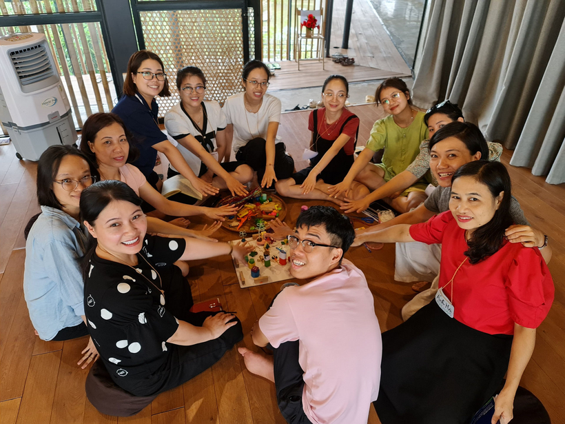 A group of people sitting around a table

Description automatically generated