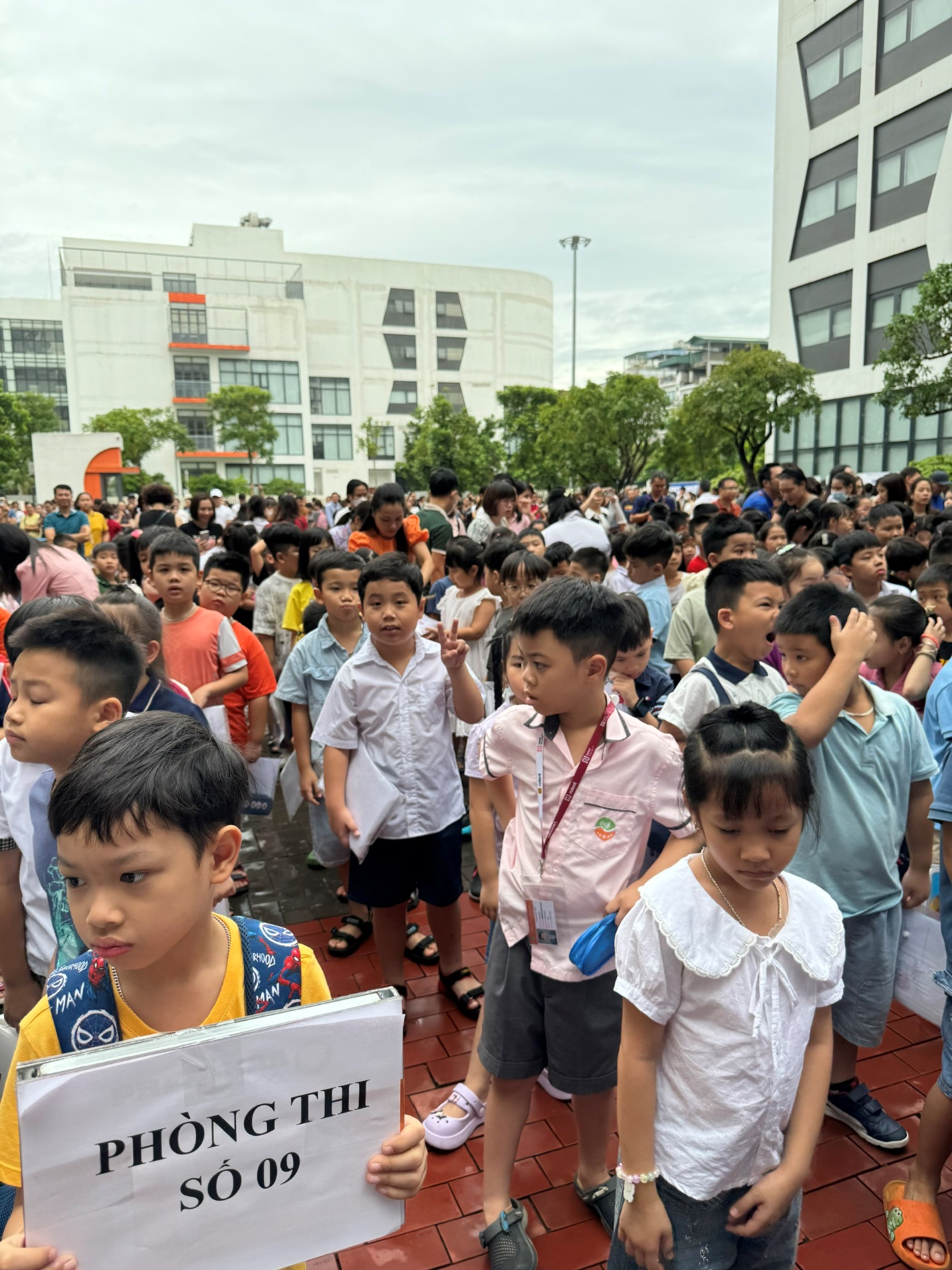 A group of children standing in a crowd
Description automatically generated