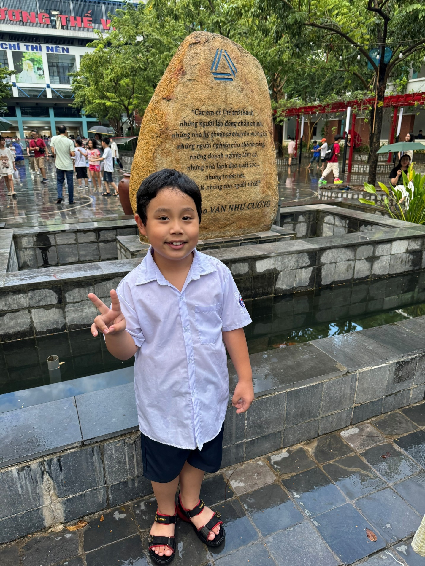 A child standing in front of a stone statue
Description automatically generated