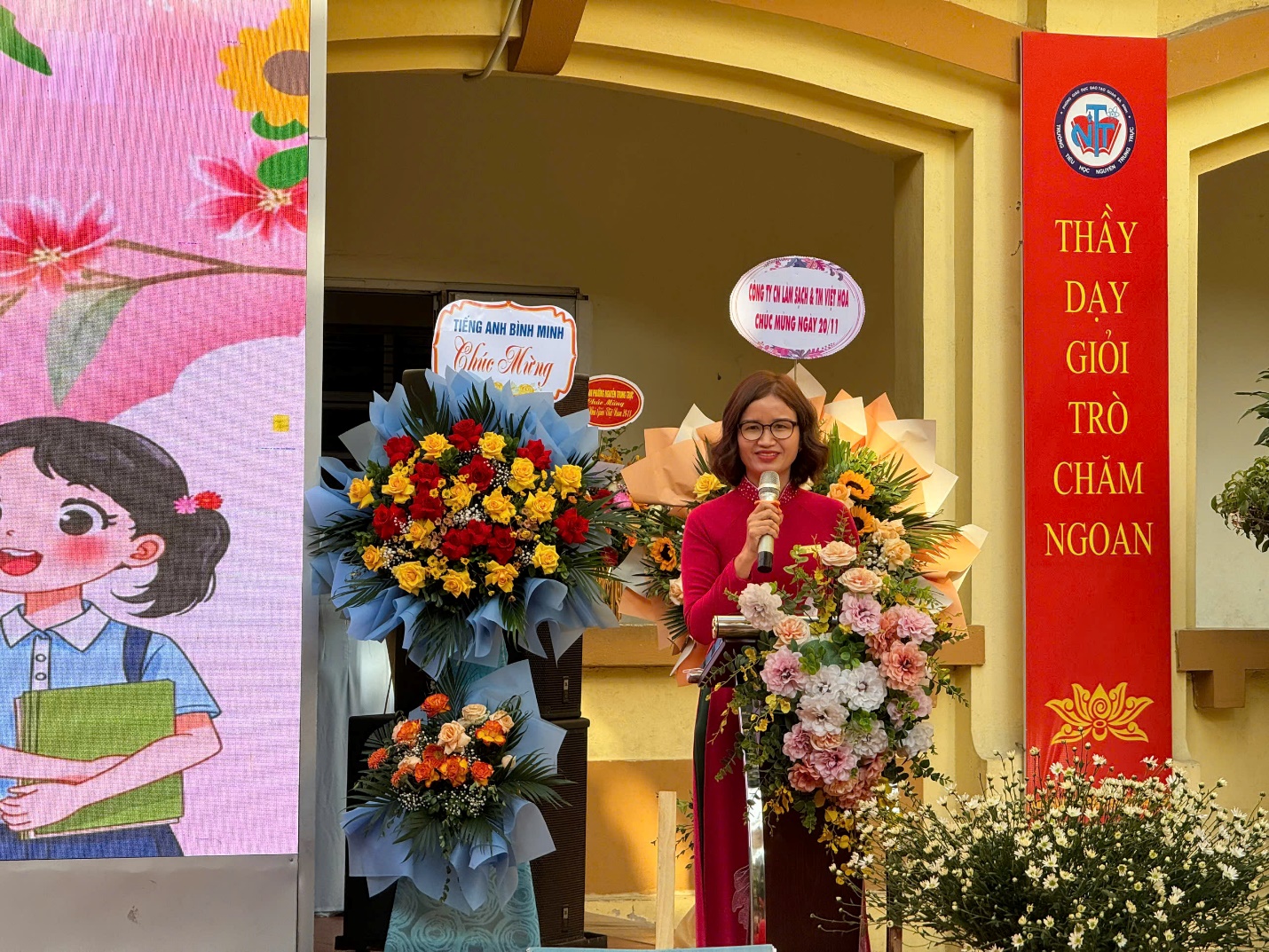 A person standing in front of a building with flowers

Description automatically generated