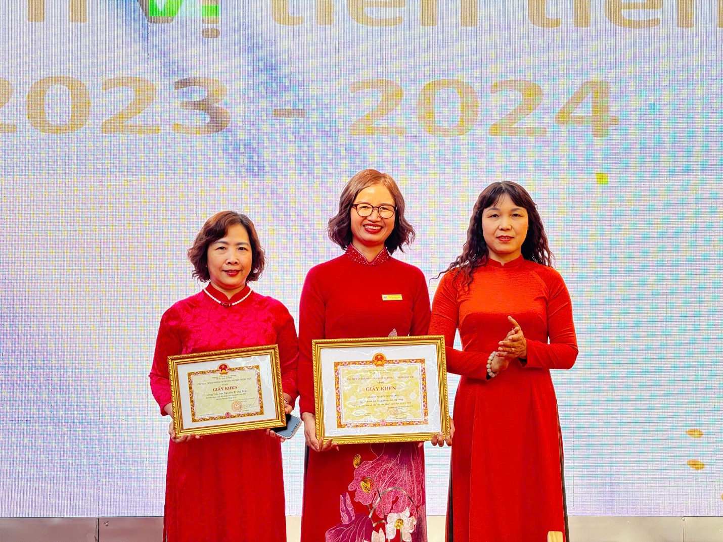A group of women holding certificates

Description automatically generated