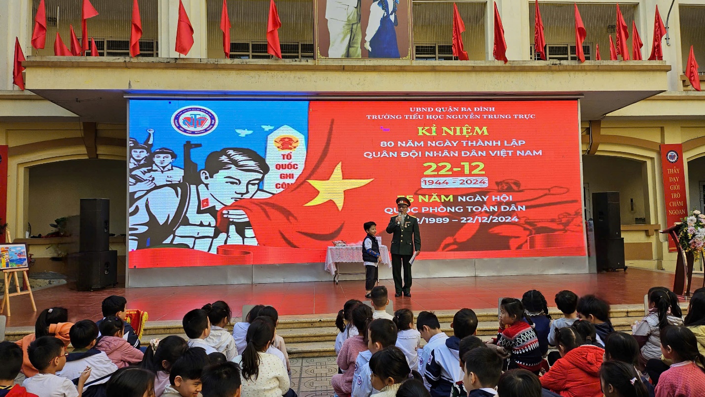 A group of people sitting on a stage
Description automatically generated