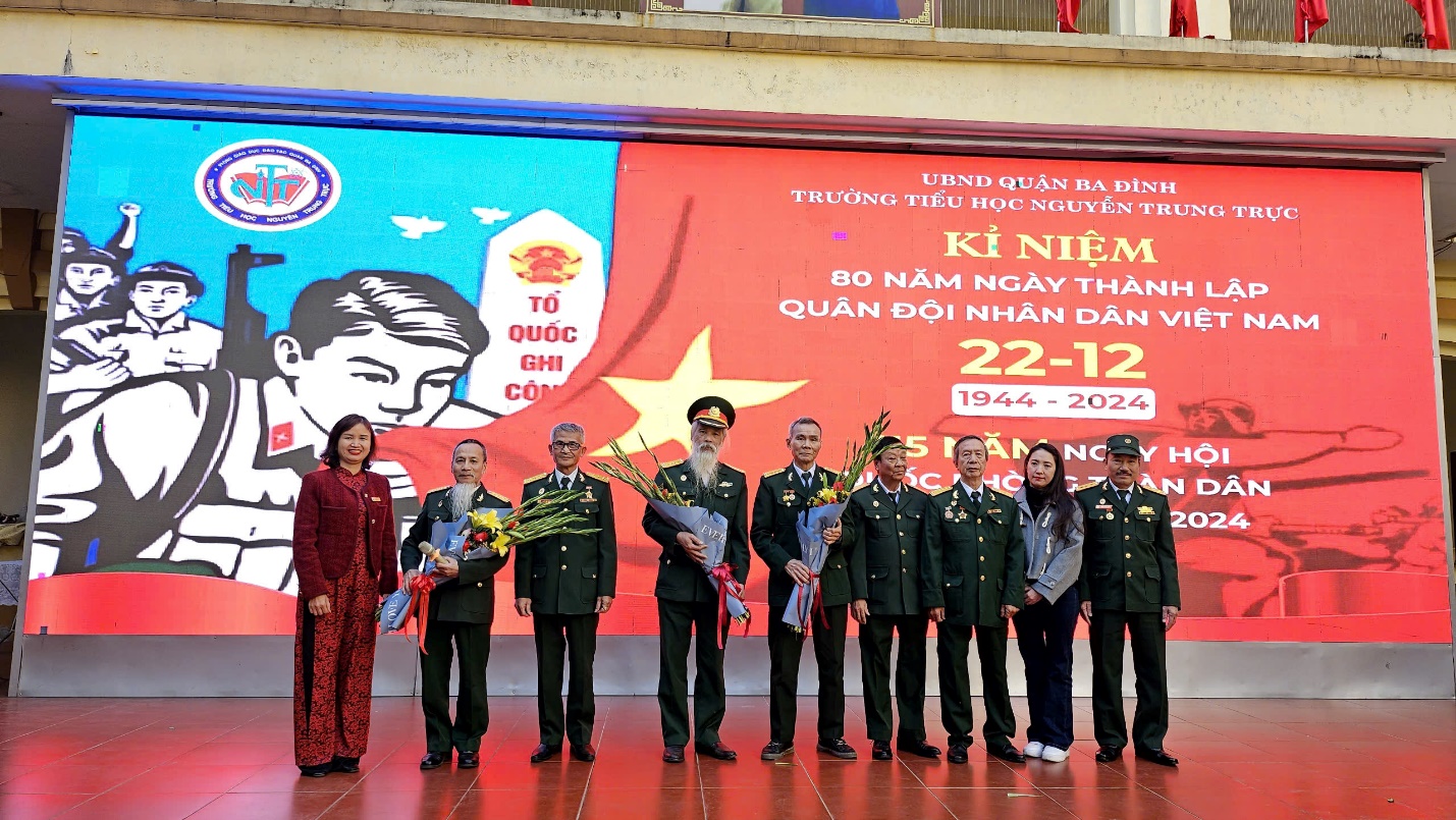A group of people in uniform standing in front of a banner
Description automatically generated