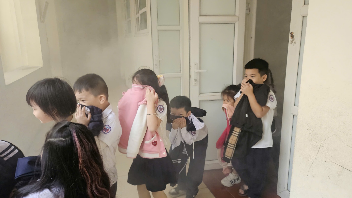 A group of children standing in a room

Description automatically generated