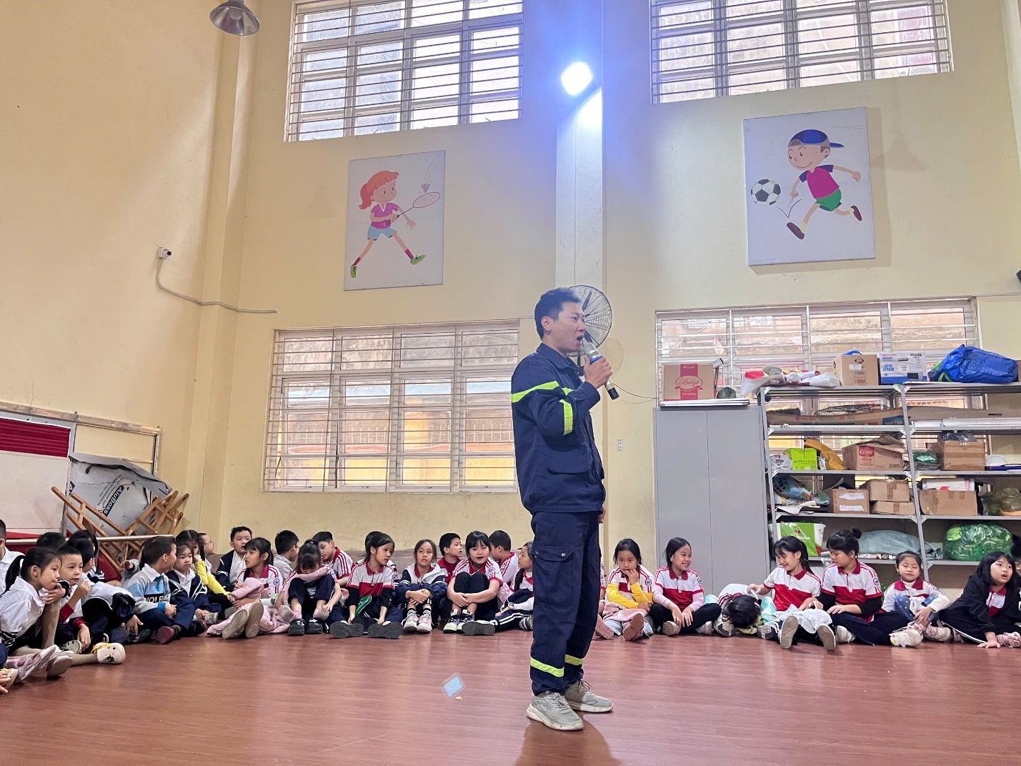 A person standing in front of a group of children

Description automatically generated