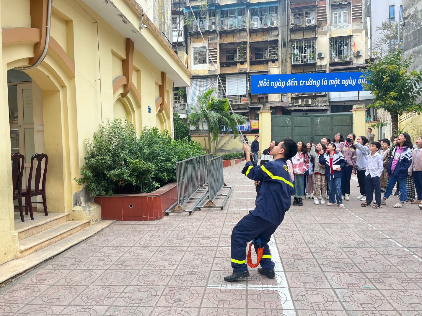 A person in a uniform on a sidewalk

Description automatically generated