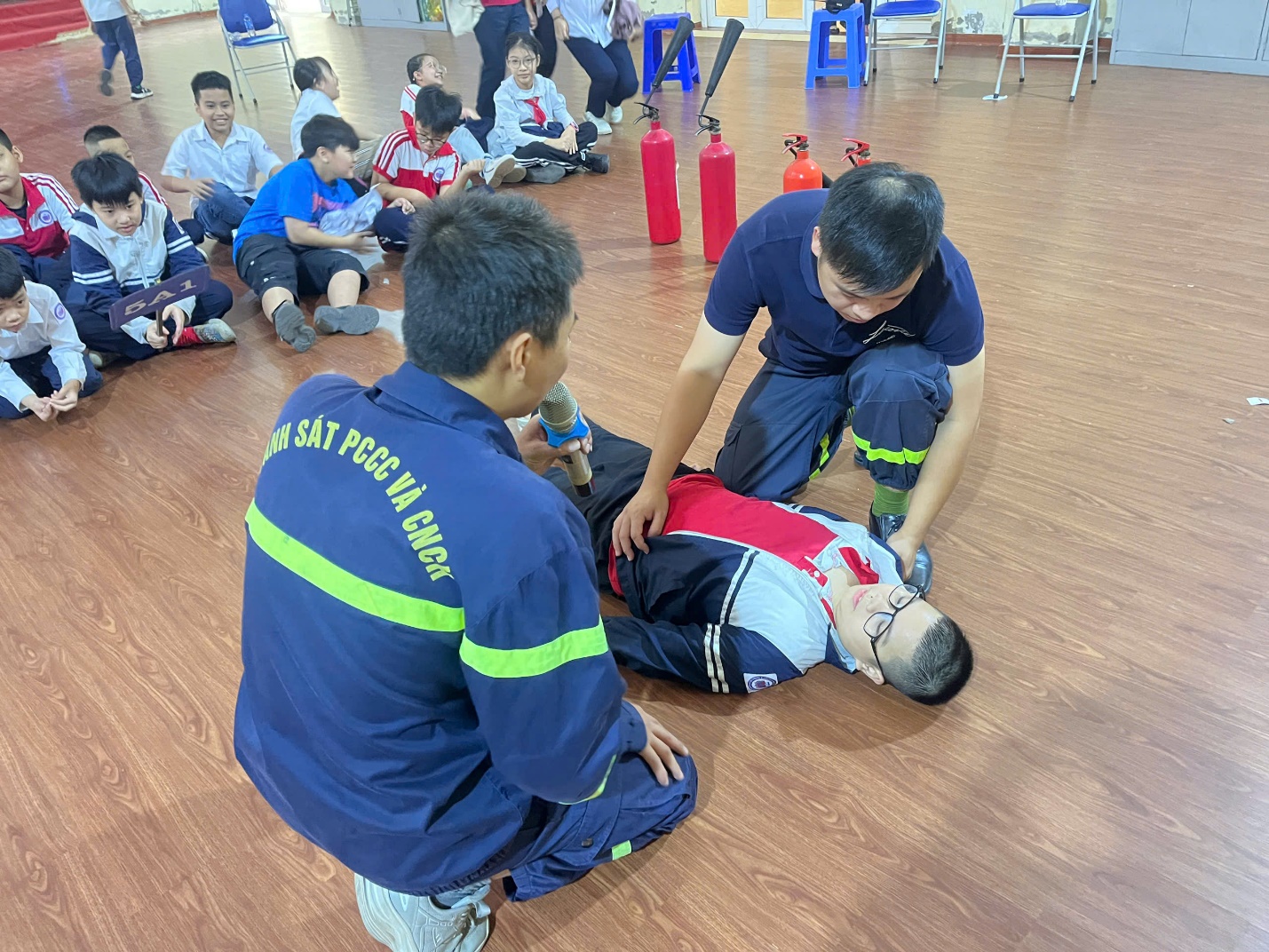 A group of people in uniform on a floor

Description automatically generated