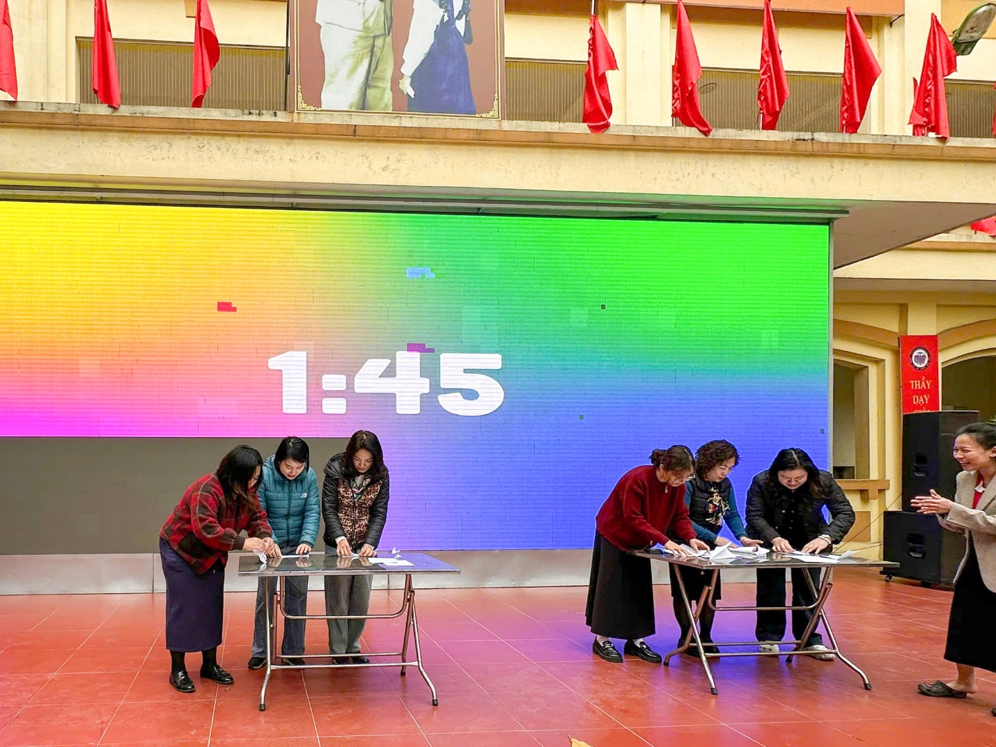 A group of women in a room with a large screen

Description automatically generated