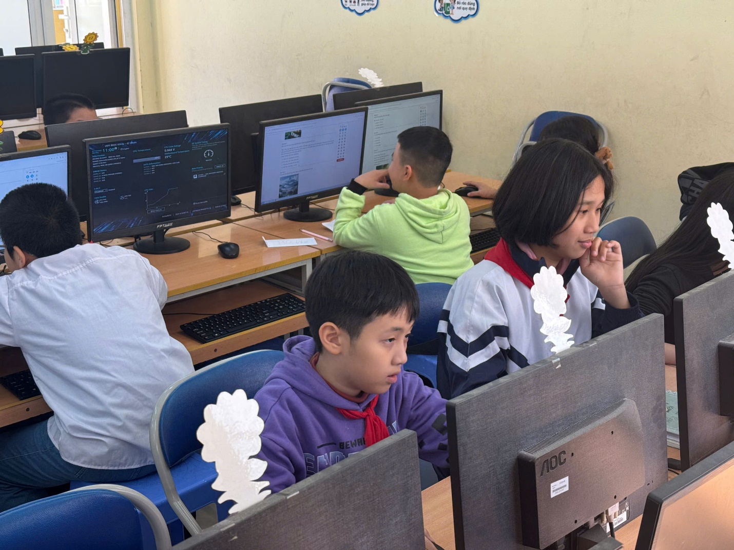 A group of people sitting at computers

Description automatically generated