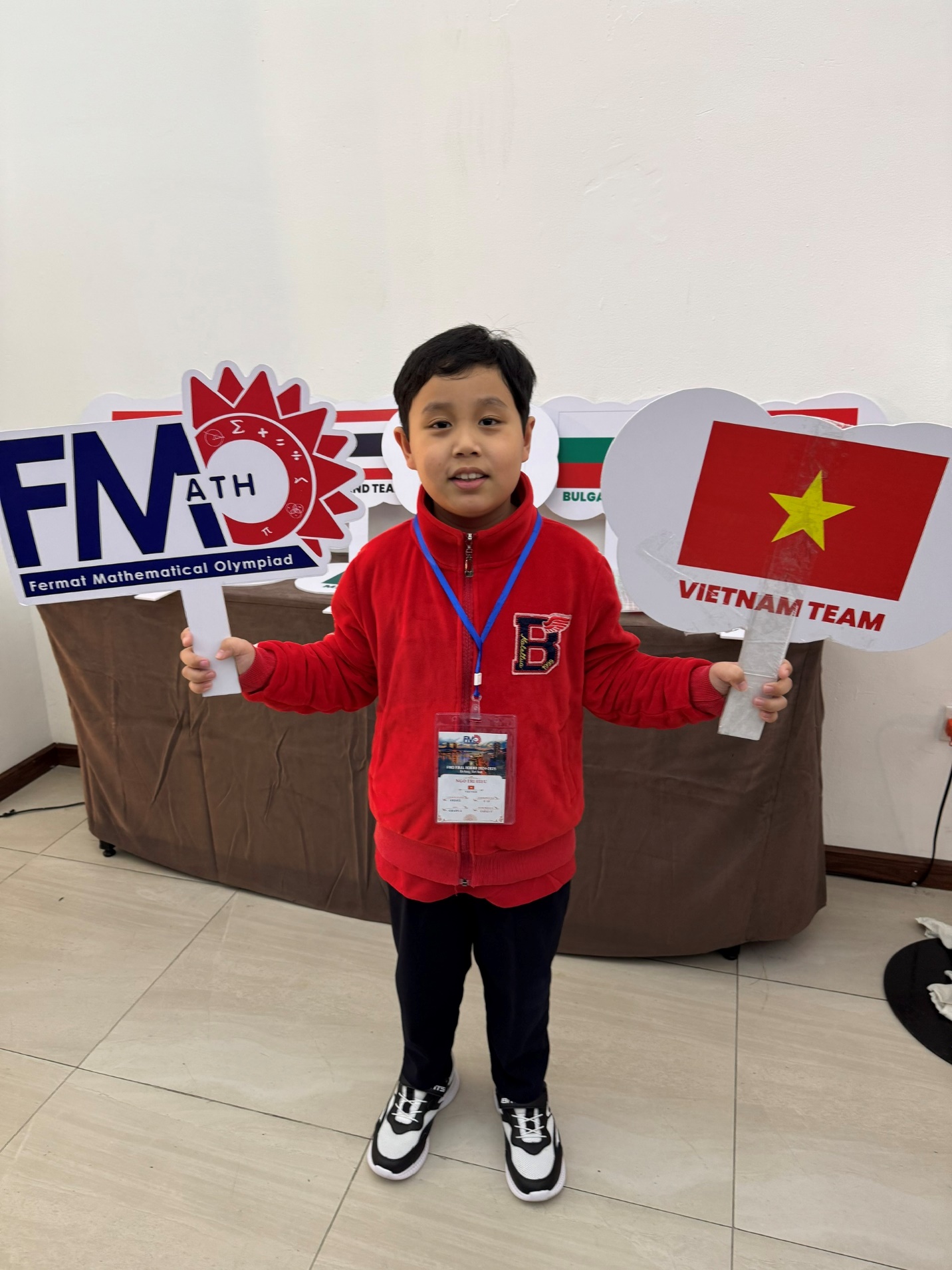 A child holding signs in front of a brown couch

Description automatically generated