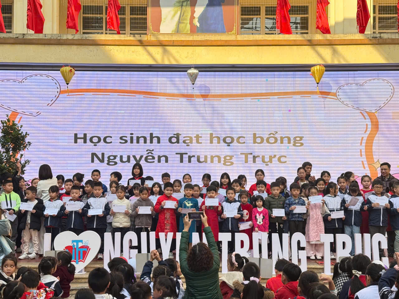 A group of children standing on a stage

Description automatically generated