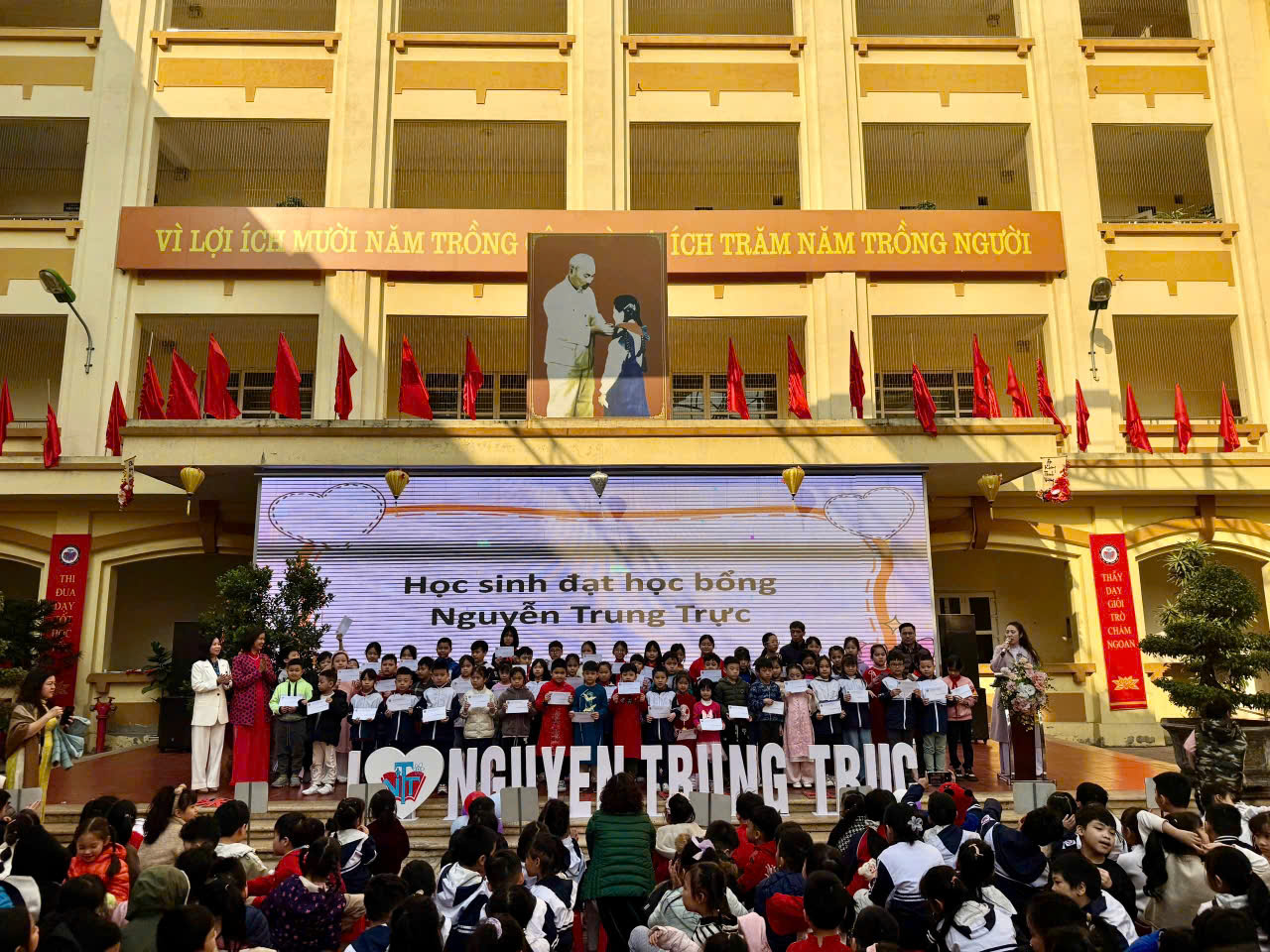 A group of people standing on a stage

Description automatically generated