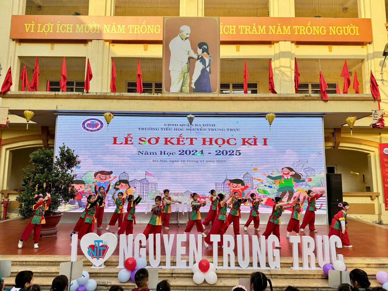 A group of people performing on a stage

Description automatically generated