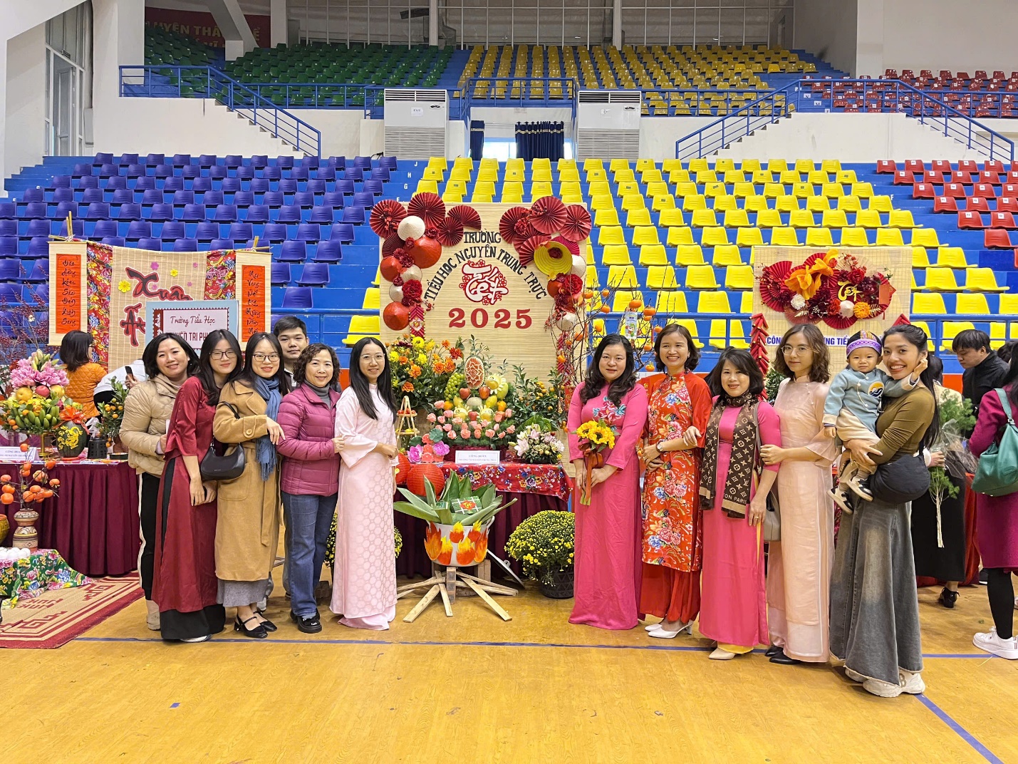 A group of people posing for a photo in a stadium

Description automatically generated