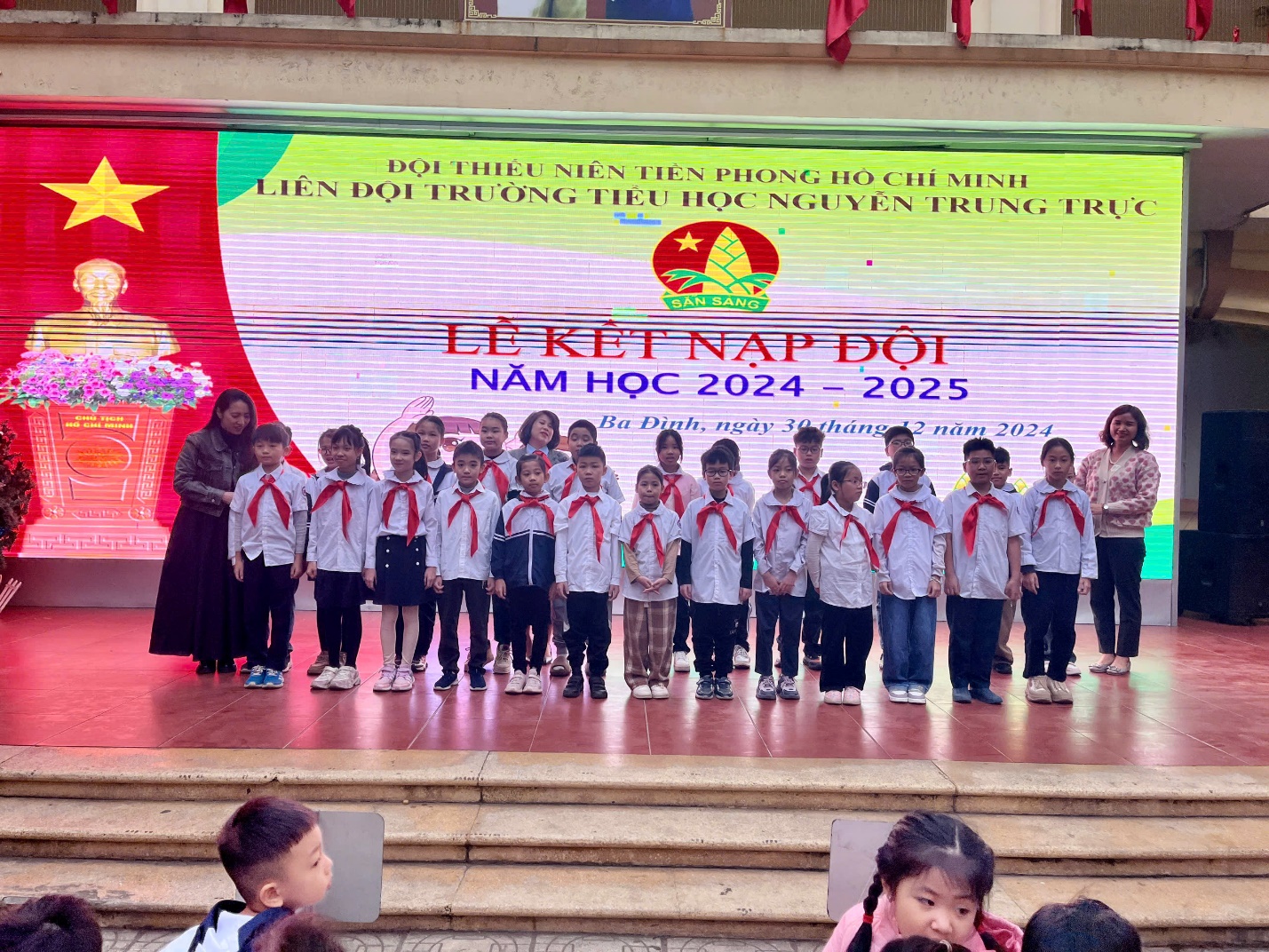 A group of children standing on a stage

Description automatically generated