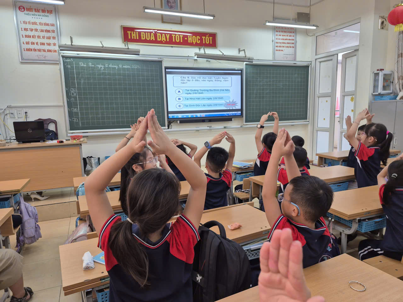 A group of children in a classroom raising their hands
AI-generated content may be incorrect.