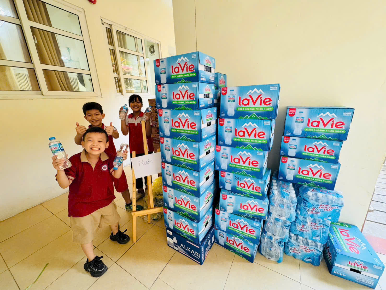 A group of kids standing next to a stack of boxes
AI-generated content may be incorrect.