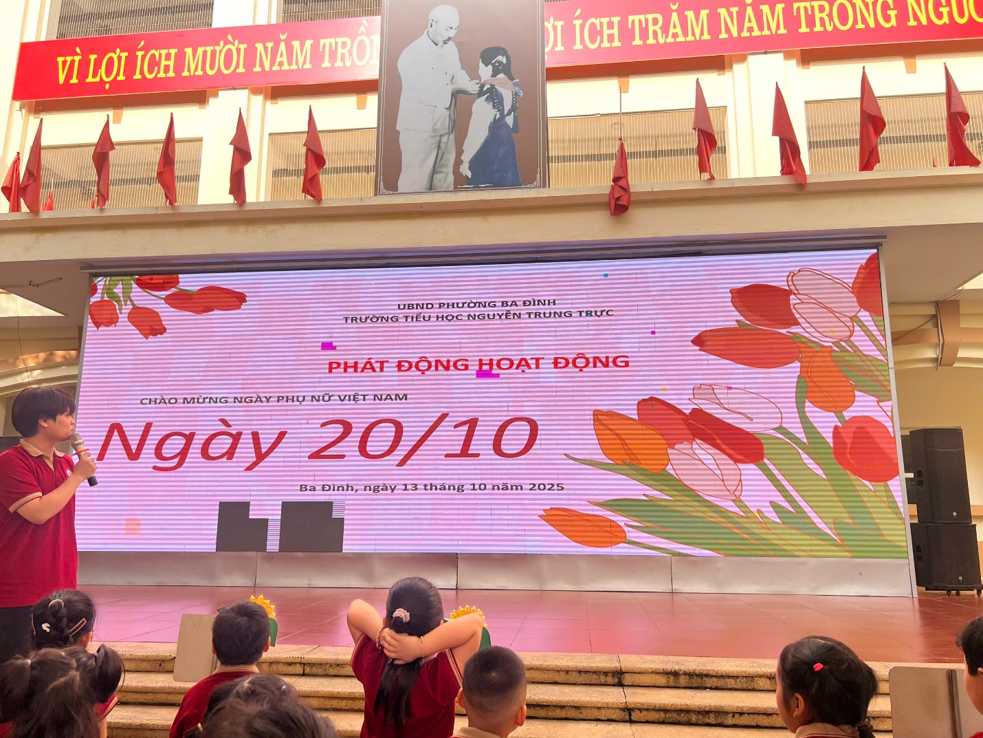 A group of people sitting on stairs in front of a large screen

AI-generated content may be incorrect.