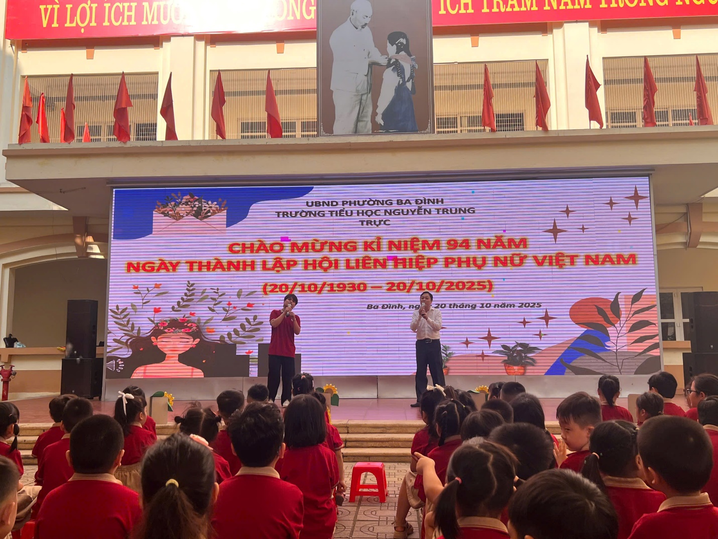 A person standing on a stage with a group of children in front of him
AI-generated content may be incorrect.