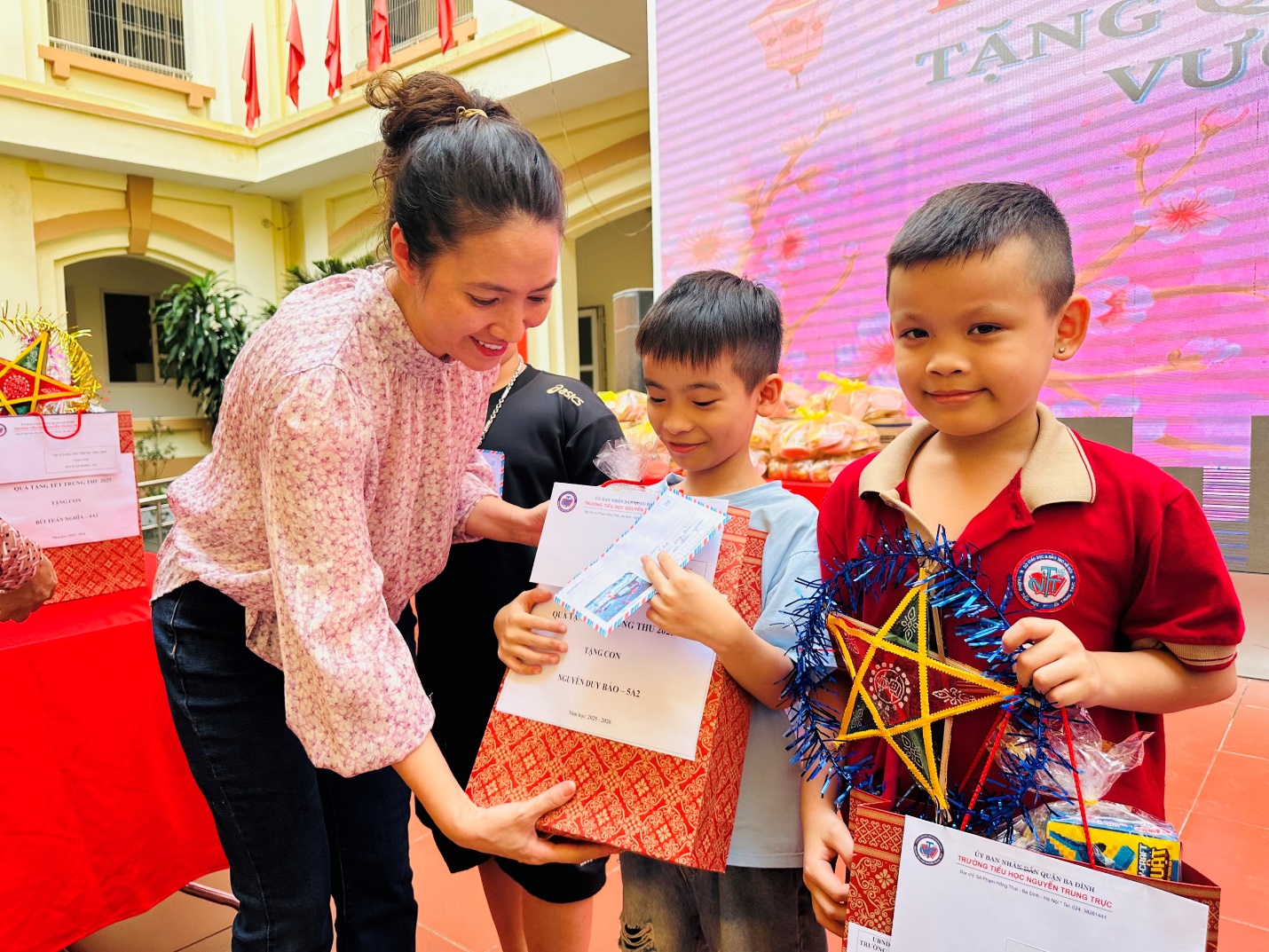 A person holding a gift bag with two children

AI-generated content may be incorrect.