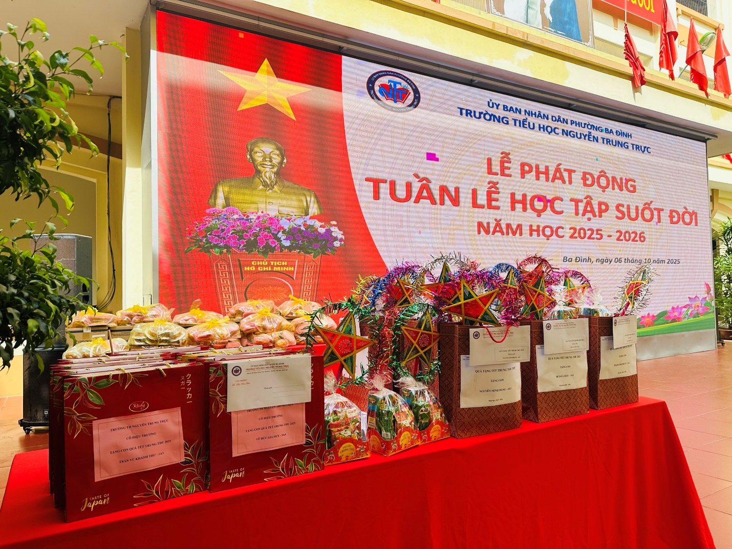 A table with a red tablecloth and a sign

AI-generated content may be incorrect.