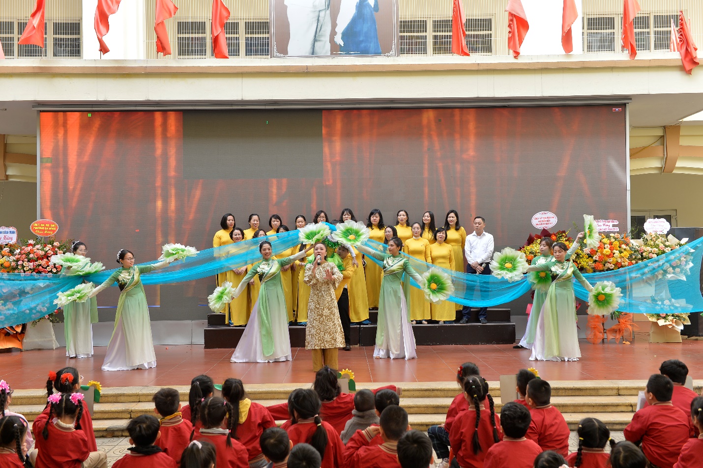 A group of women performing on a stage

AI-generated content may be incorrect.