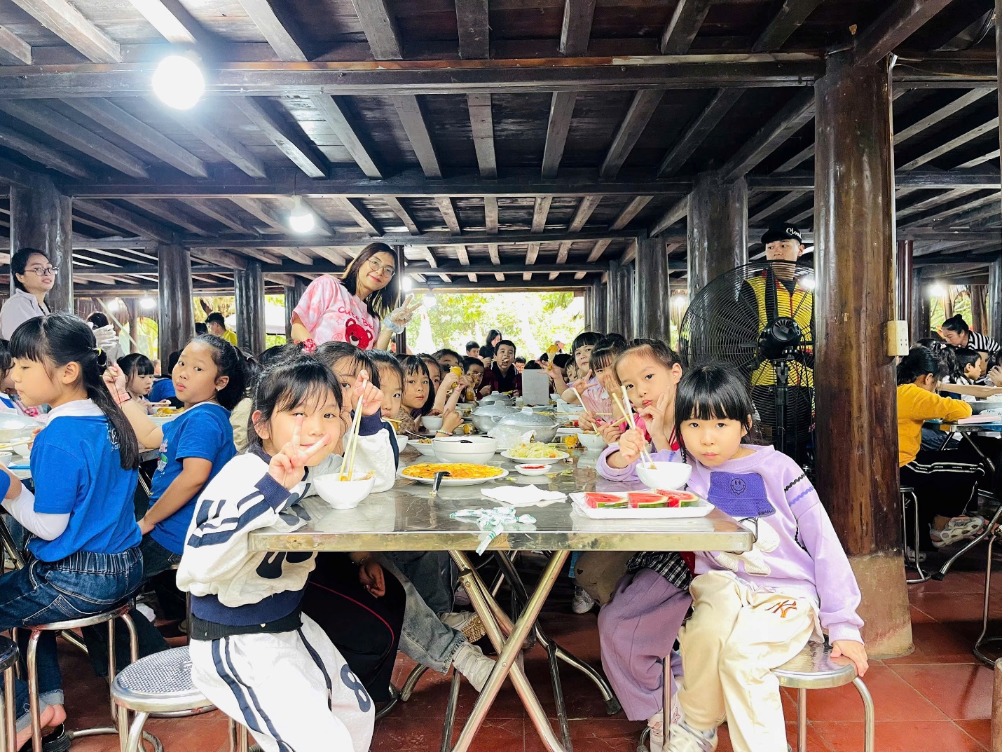 A group of children sitting at a table

AI-generated content may be incorrect.