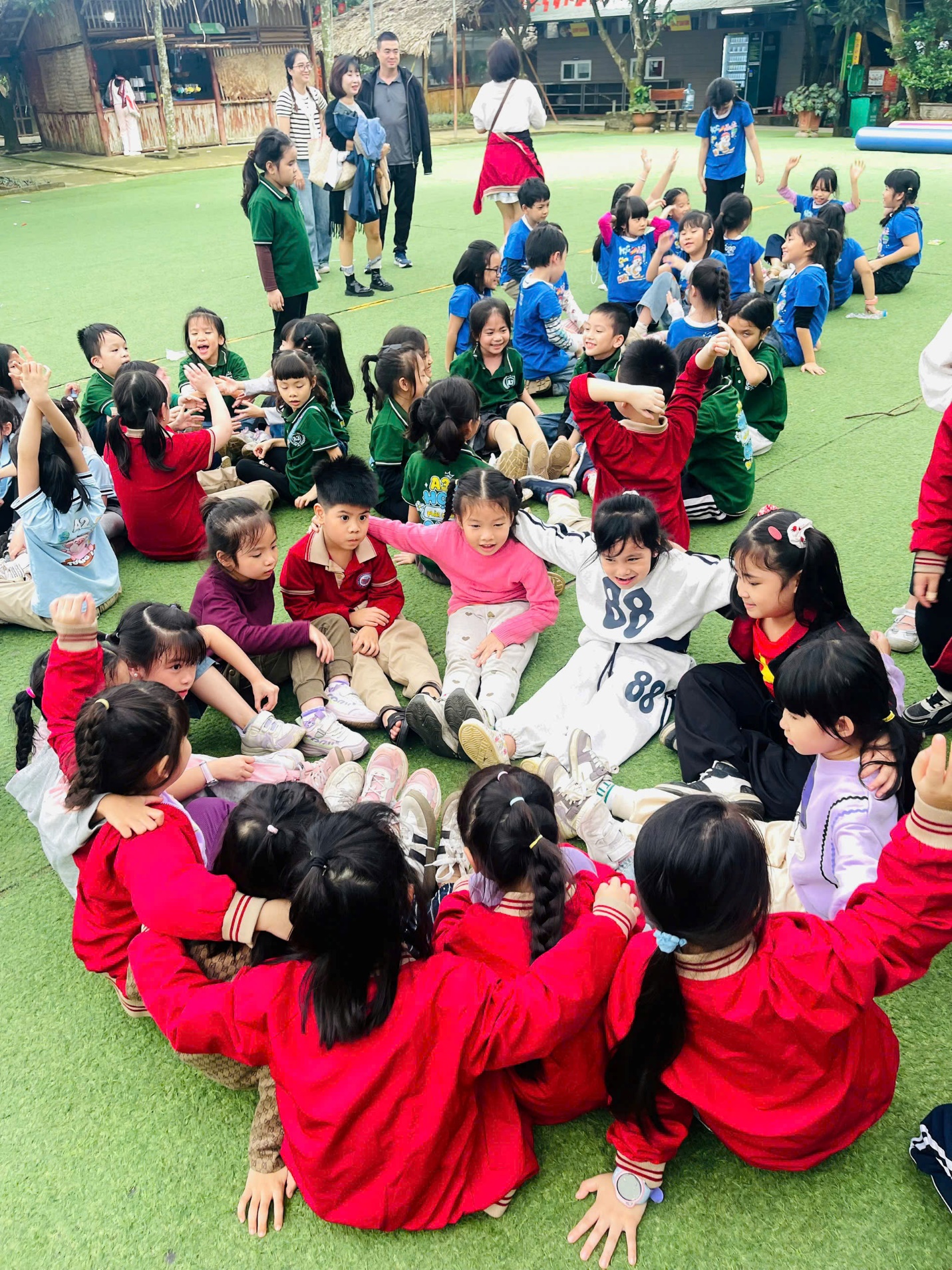 A group of children sitting on the ground

AI-generated content may be incorrect.