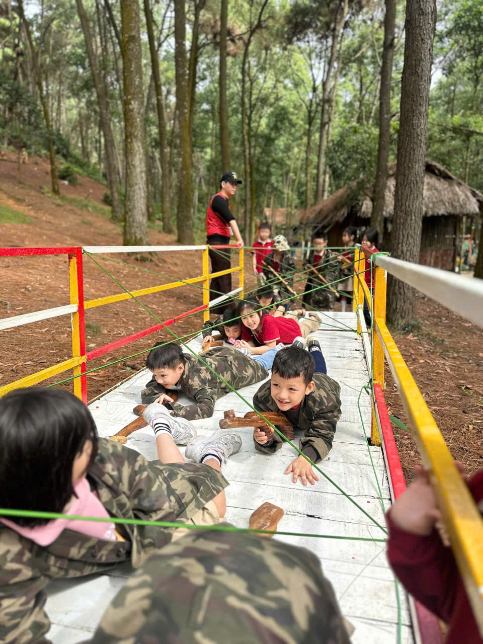 A group of children lying on a bridge

AI-generated content may be incorrect.