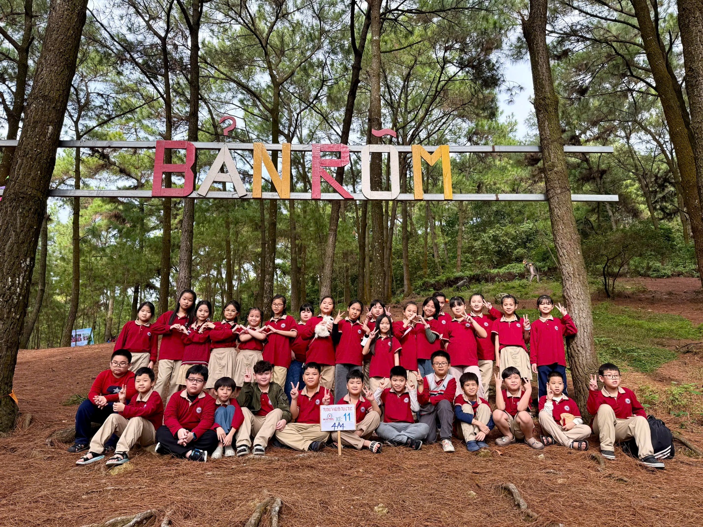 A group of people posing for a photo under a sign

AI-generated content may be incorrect.