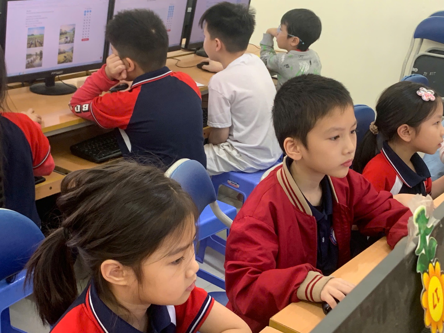 A group of children sitting at desks in a classroom

AI-generated content may be incorrect.