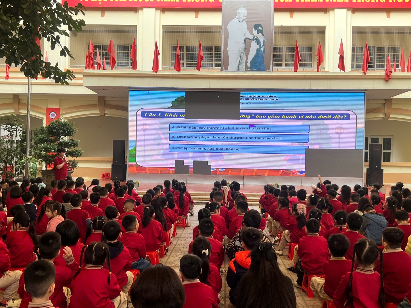 A group of people in red uniforms sitting on the stage

AI-generated content may be incorrect.