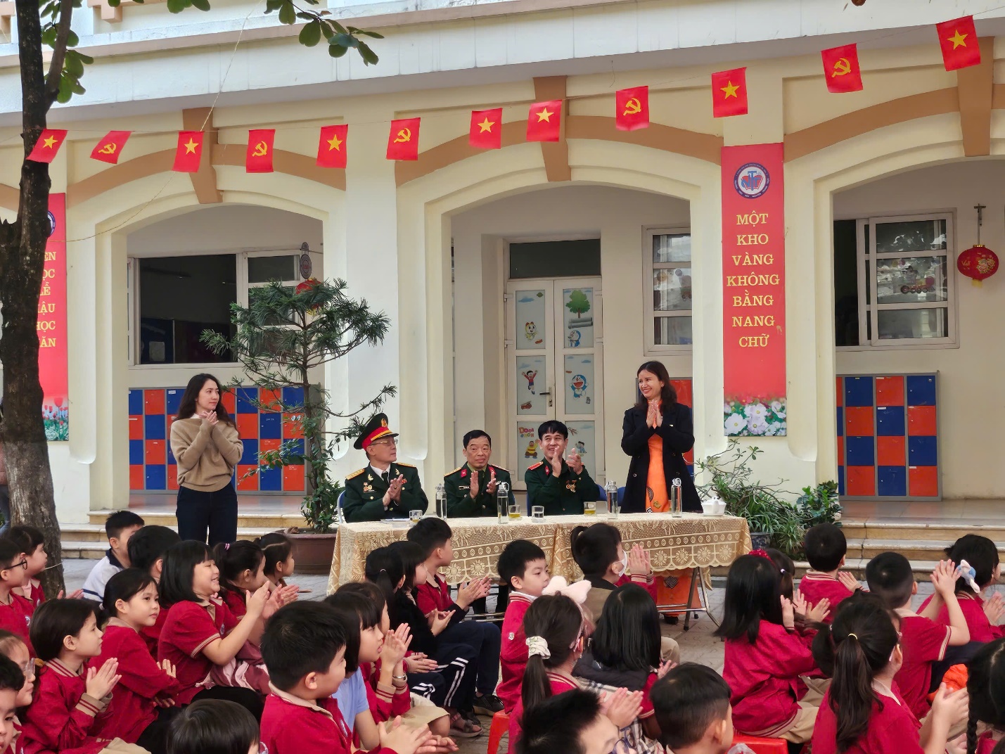 A group of children sitting in front of a building

AI-generated content may be incorrect.