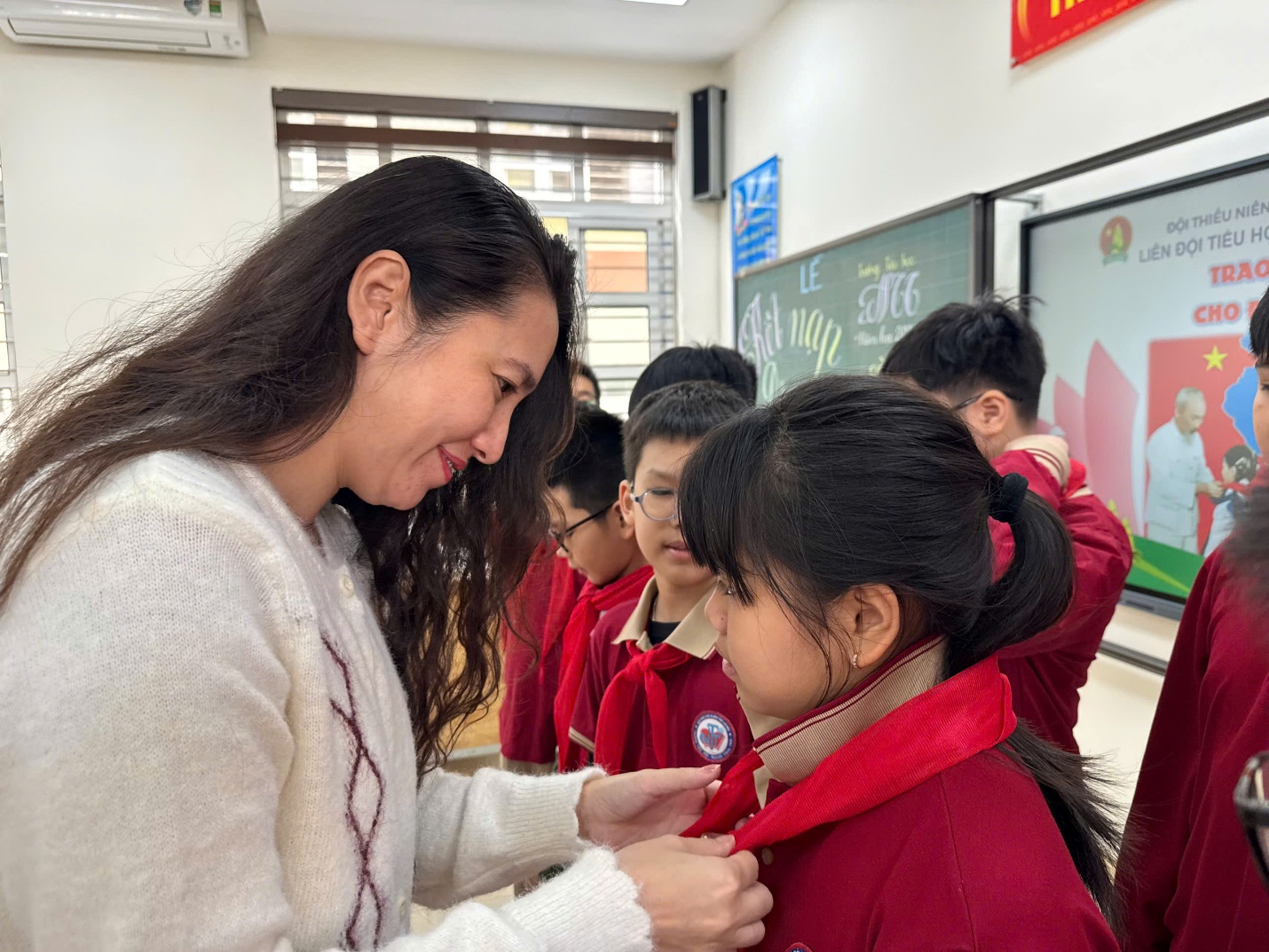 A person helping a child with a red scarf

AI-generated content may be incorrect.