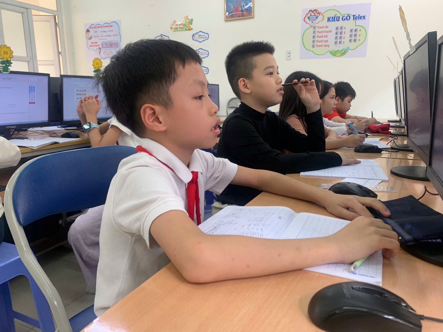 A group of children sitting at a desk in a classroom

AI-generated content may be incorrect.