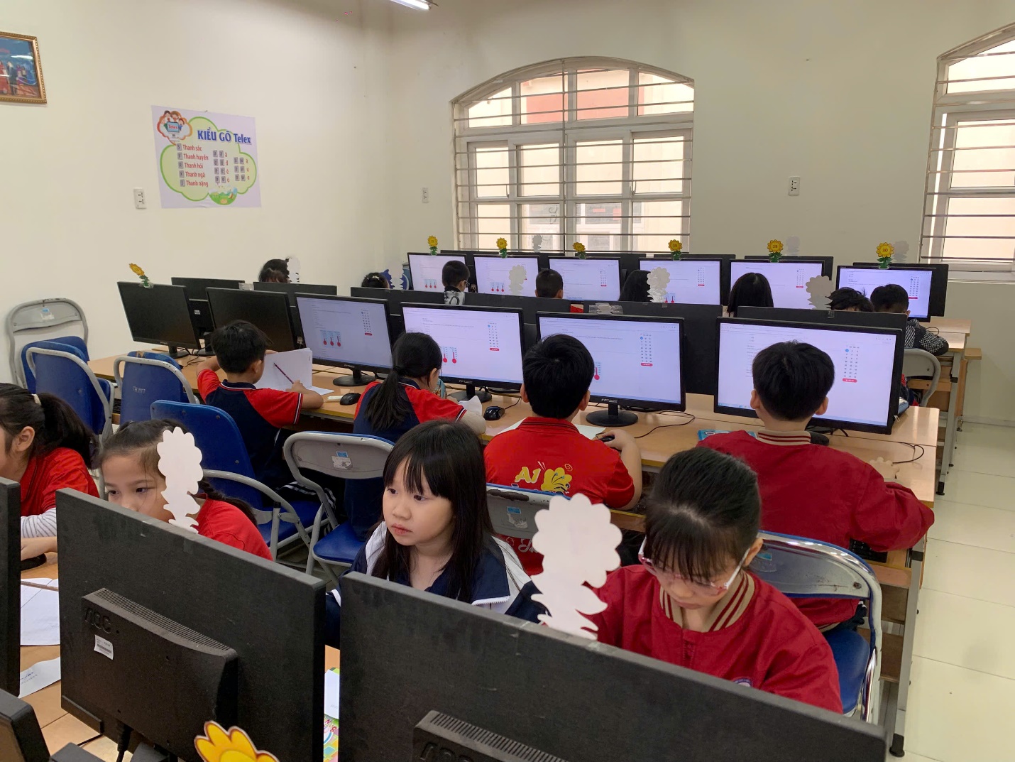 A group of children in a classroom with computers

AI-generated content may be incorrect.