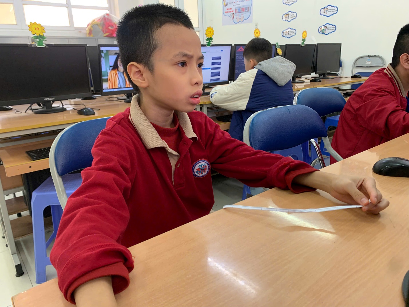 A child sitting at a desk with a paper in his hand

AI-generated content may be incorrect.