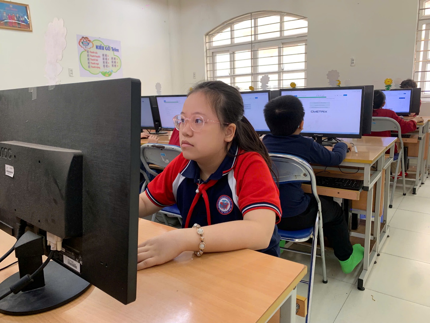 A child sitting at a desk with a computer

AI-generated content may be incorrect.