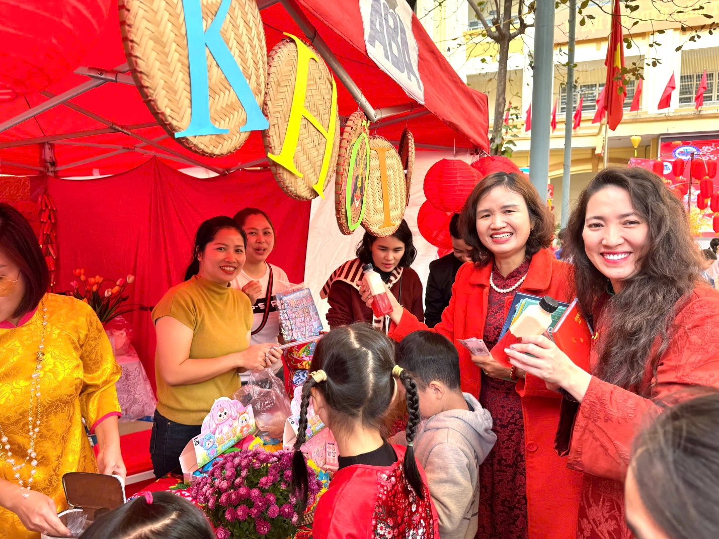 A group of women standing in front of a tent

Description automatically generated