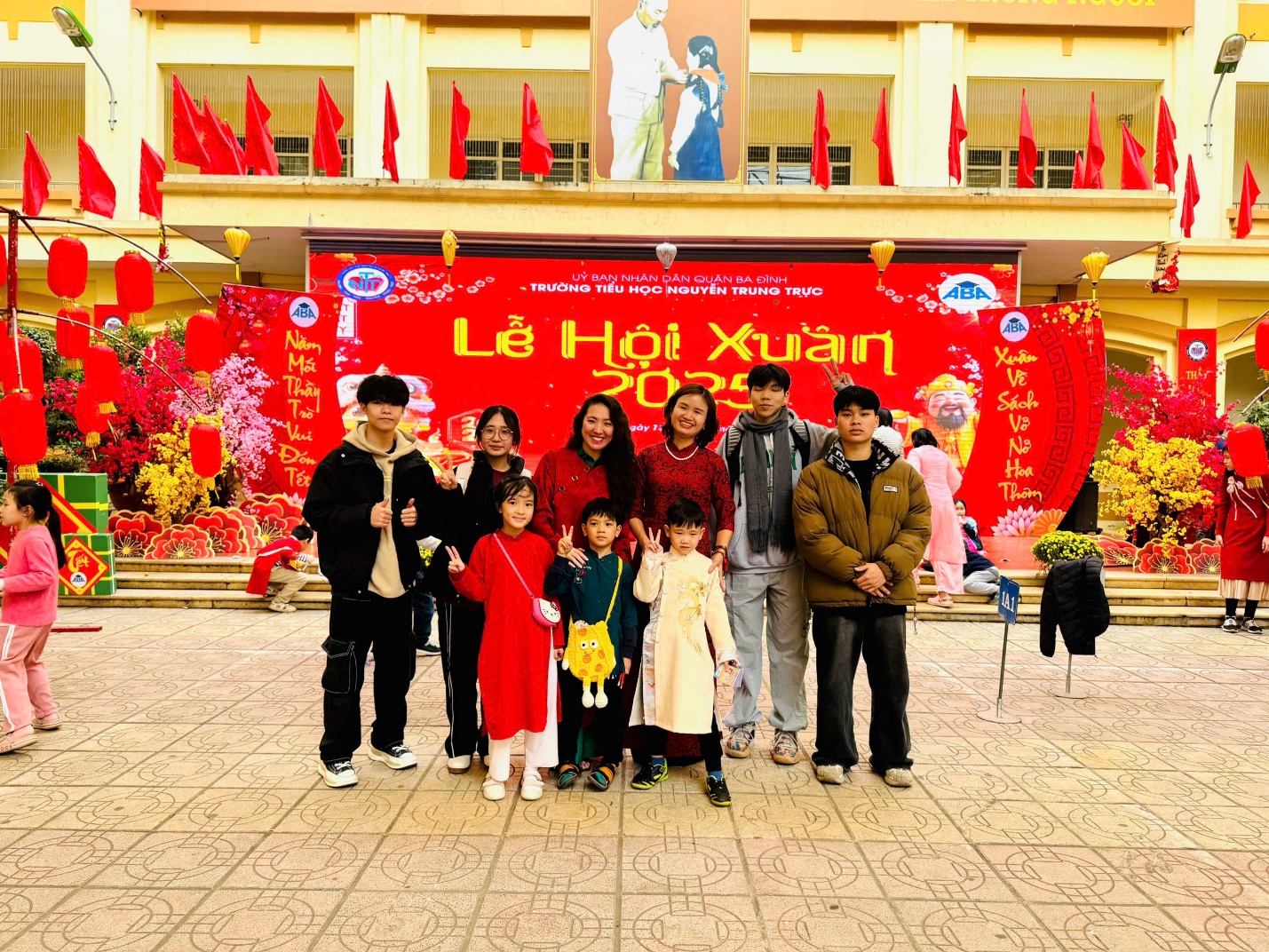 A group of people posing for a photo

Description automatically generated