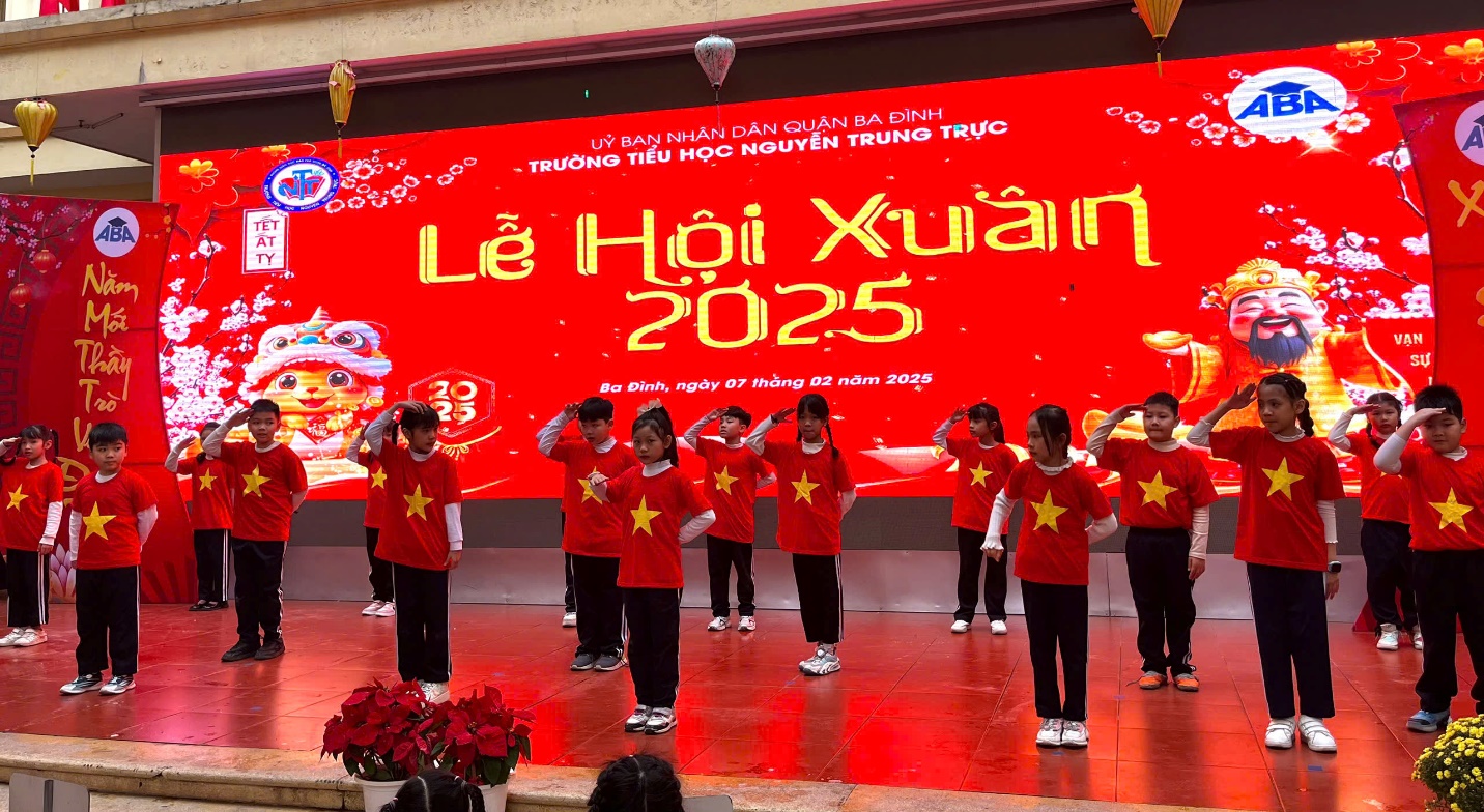 A group of people in red shirts on a stage

Description automatically generated