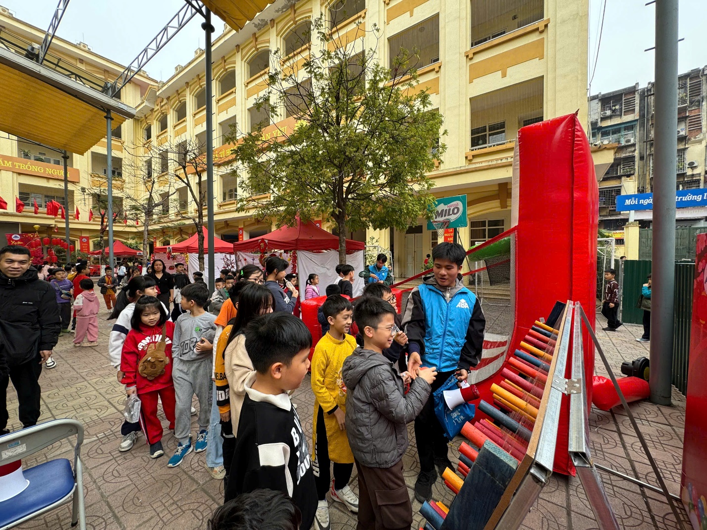 A group of people standing in a street

Description automatically generated