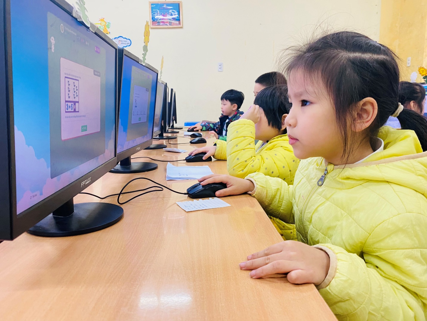 A group of children sitting at a desk using computers

AI-generated content may be incorrect.