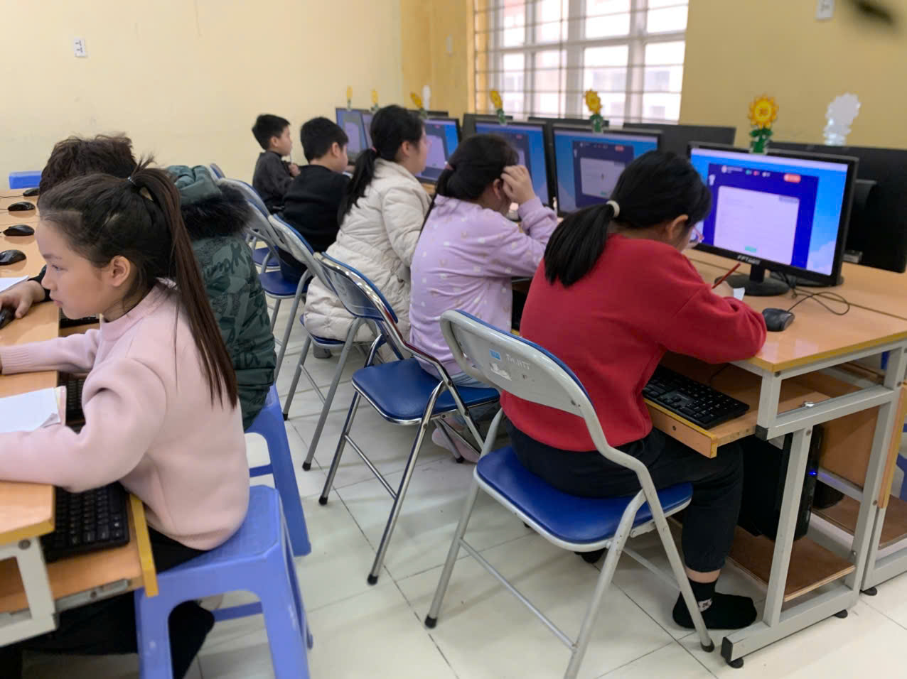 A group of people sitting at desks using computers

AI-generated content may be incorrect.