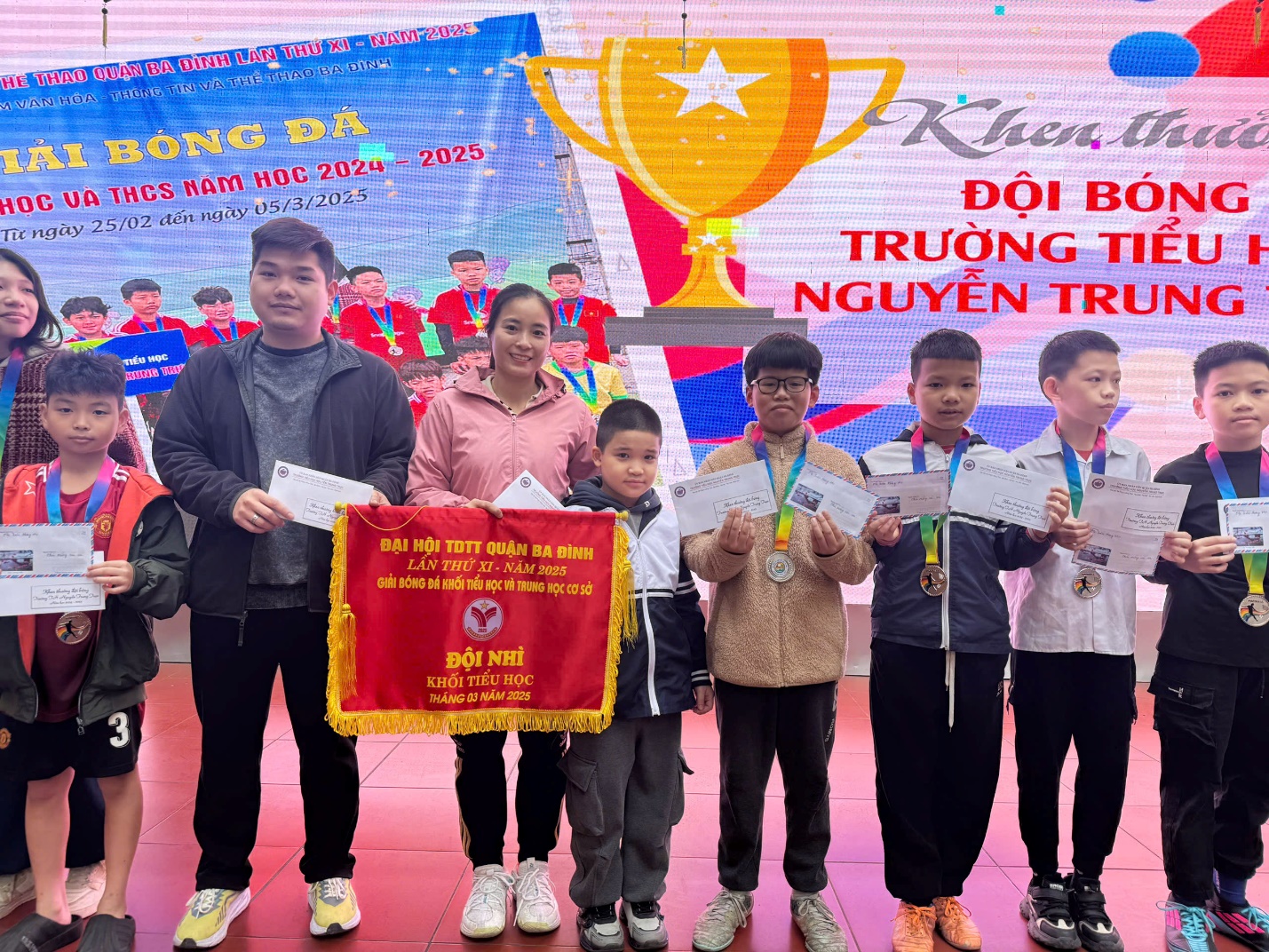 A group of people holding banners and medals

AI-generated content may be incorrect.