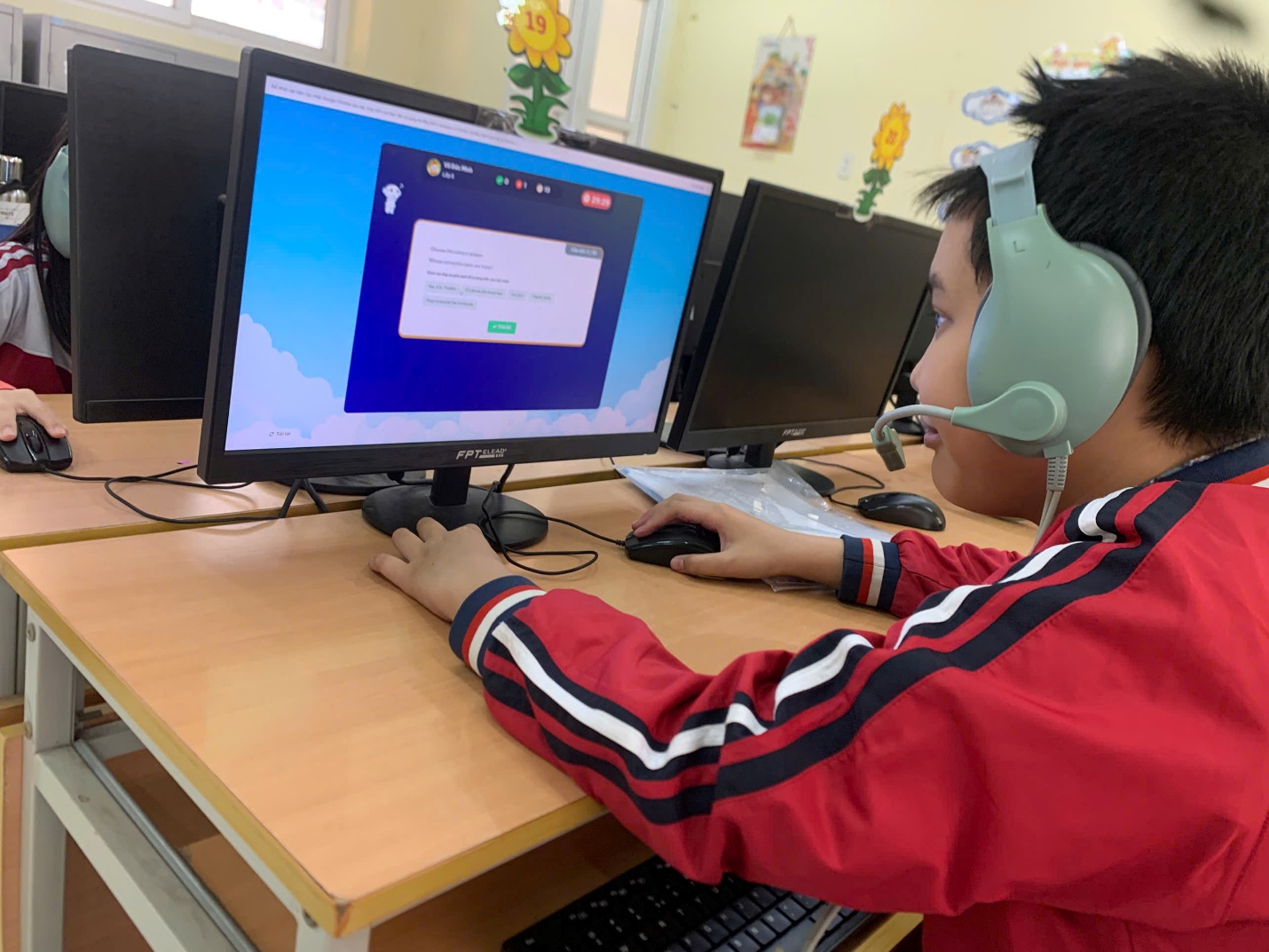 A child wearing a headset and sitting at a desk with computers

AI-generated content may be incorrect.